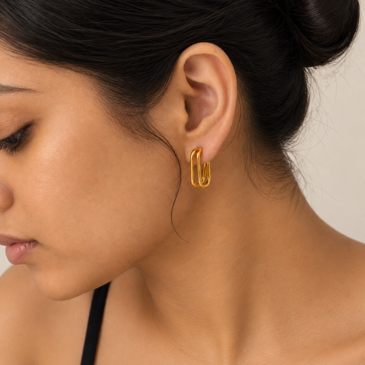 18k gold-plated double hoop earring worn on model's ear, close-up profile view - Miromor